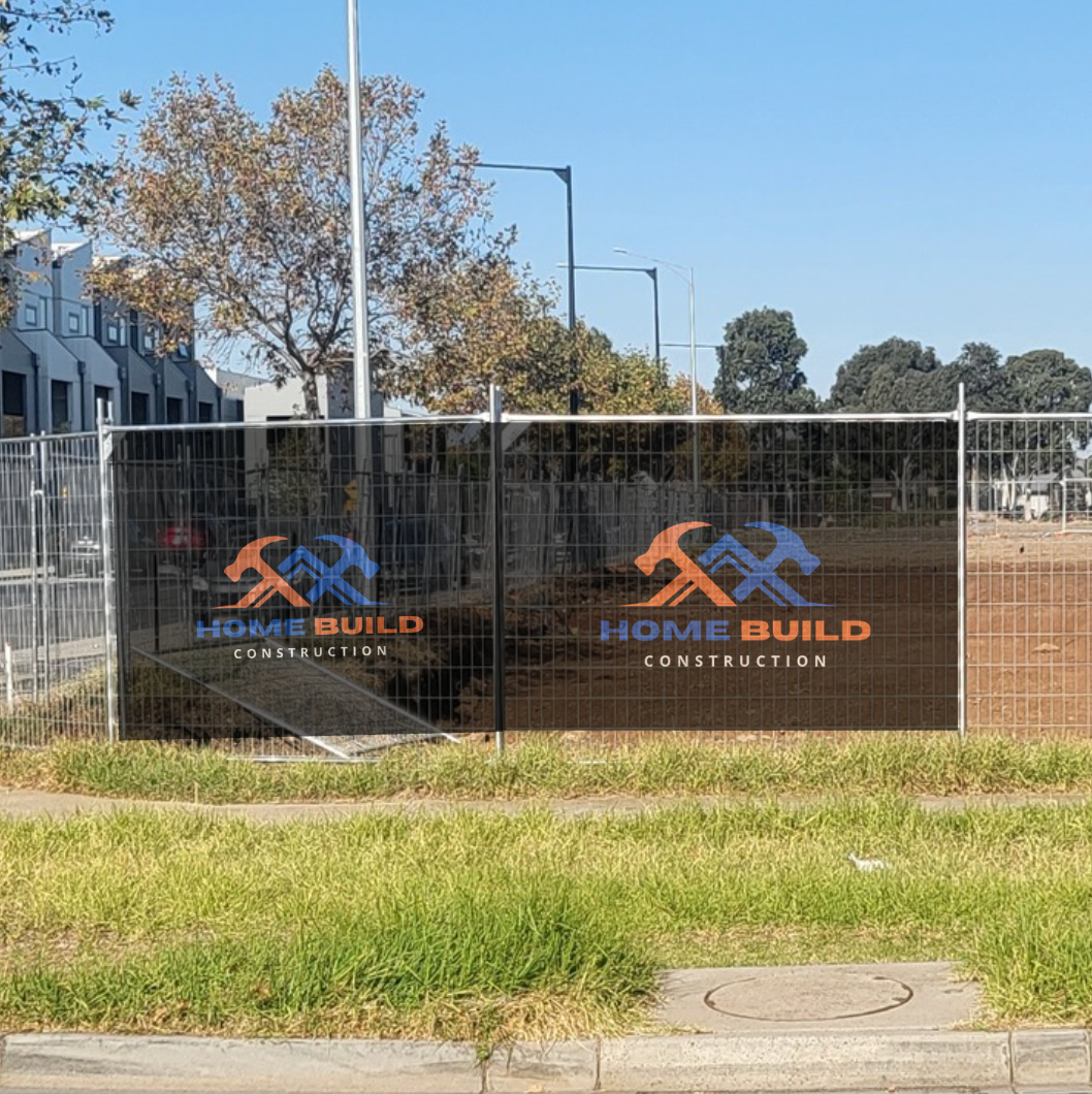 Construction site with 'Home Build Construction' logo on a fence mesh banner