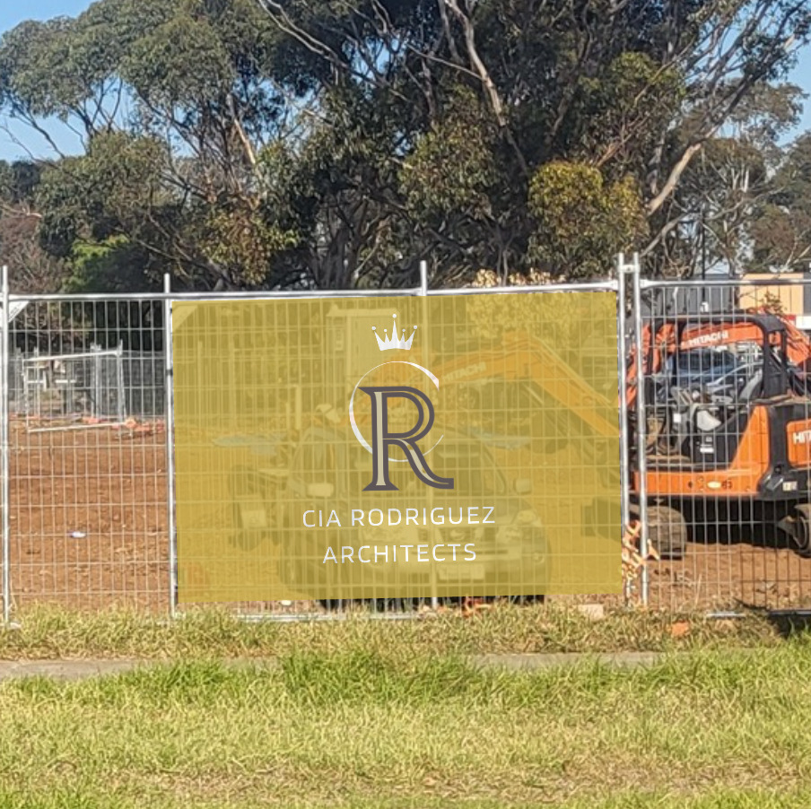 CIA Rodriguez Architects mesh banner sign on a construction site with an excavator in the background