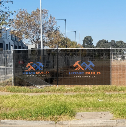 Construction site with 'Home Build Construction' logo on a fence mesh banner