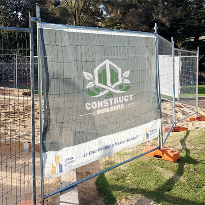 Construction site mesh banner with a branded safety fence displaying 'Construct Builders' logo.